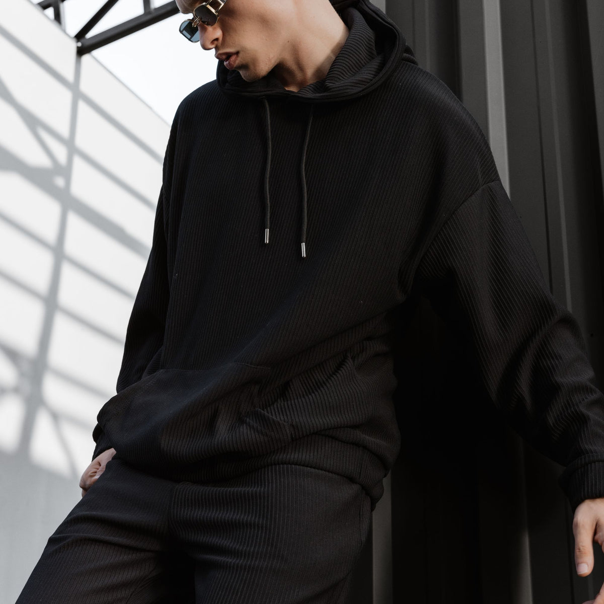 Model wearing a black pullover hoodie