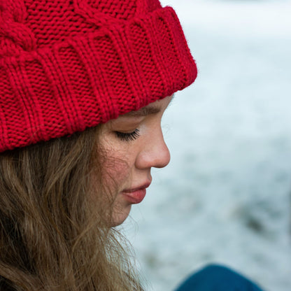 Woman wearing a red cuffed knit beanie