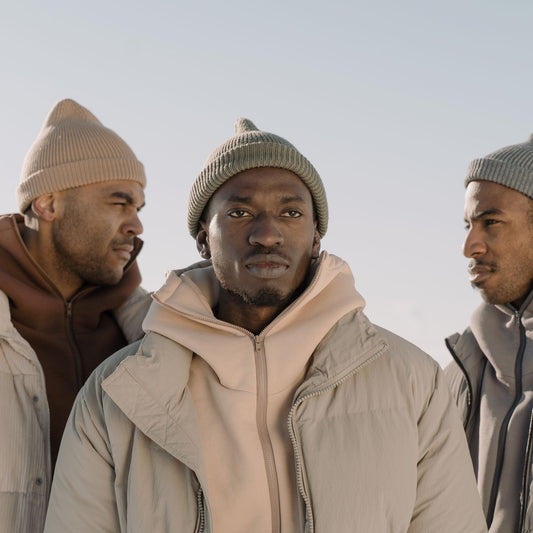 Three people wearing knit beanies