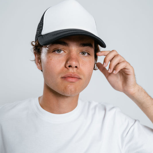 Model wearing a custom trucker hat ready for embroidery