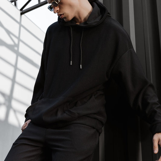 Model wearing a black pullover hoodie ready for a custom print