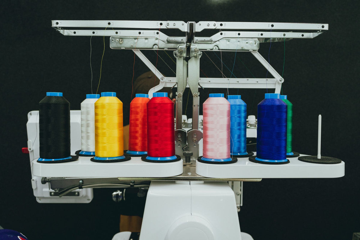 Colorful thread spools on a commercial embroidery machine