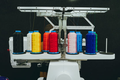 Colorful thread spools on a commercial embroidery machine