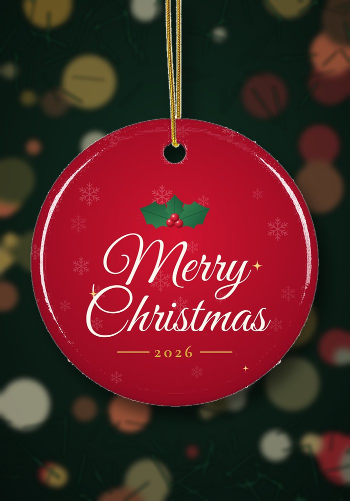 Merry Christmas 2026 ornament hanging on a Christmas tree