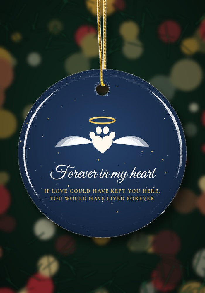Pet memorial ornament with angel paw hanging on a Christmas tree
