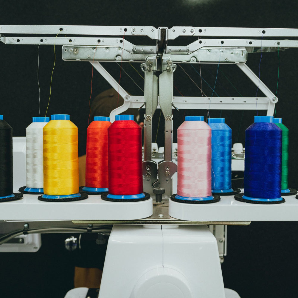 Colorful thread spools on a commercial embroidery machine