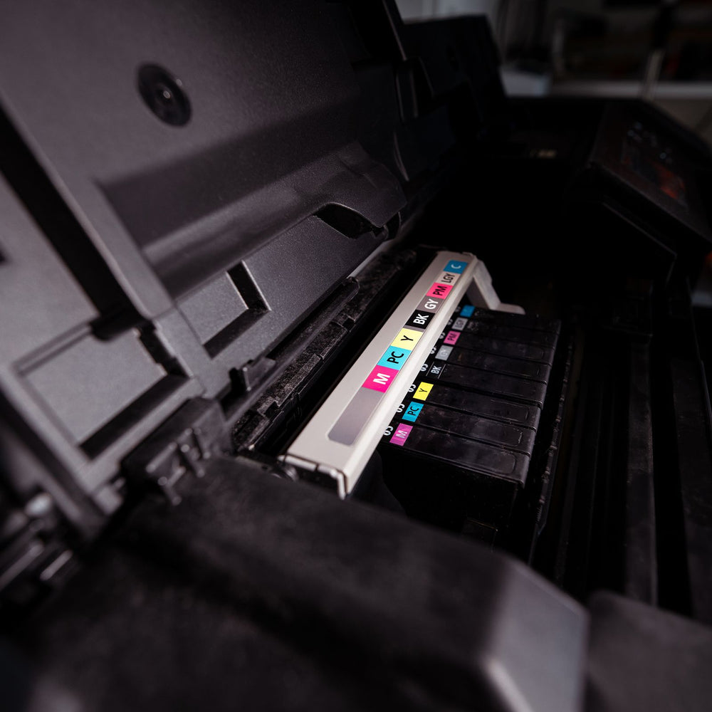 CMYK ink cartridges inside a printer