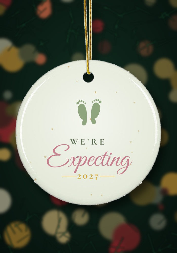 We're Expecting ornament hanging on a Christmas tree
