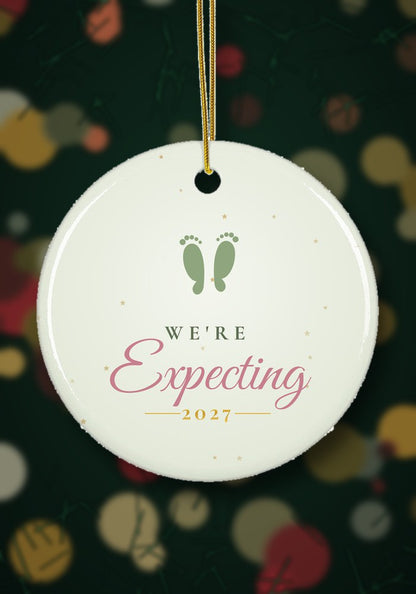 We're Expecting ornament hanging on a Christmas tree